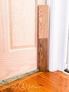 an open door with wood flooring next to it