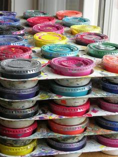 a pile of different colored spools sitting on top of each other