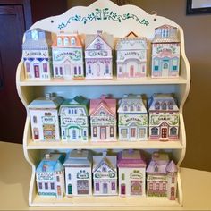 a shelf filled with lots of little houses on top of it's side shelves