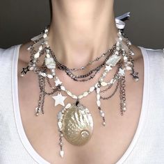 @fairycorejewelry on Instagram: "This mermaid inspired piece is now available on my Etsy! 🐚🤍 Made with freshwater, baroque pearls, shell beads, clear quartz crystals, stainless steel chains and charms, various beads and finished off with a shell pendant! 🤍🎀 . . . . #gothicnecklace #handmadejewelry #necklace #necklaces #freshwaterpearls #whimsigoth #goth #gothicfashion #gothiclolita #jewellery #jewelry #fairycore #aesthetic #y2k #grunge #grungeaesthetic #coquette #gothaesthetic #darkacademi Mermaid Jewelry Aesthetic, Mermaid Jewlery, Mermaid Necklace Aesthetic, Mermaid Core Necklace, Gothic Fairycore, Siren Jewelry, Mermaidcore Necklace, Goth Mermaid, Mermaid Jewelry Necklaces