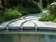 an outdoor garden with water features and plants