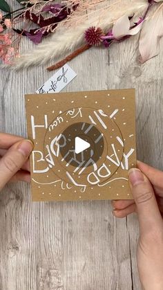 someone holding up a card with the words happy birthday on it