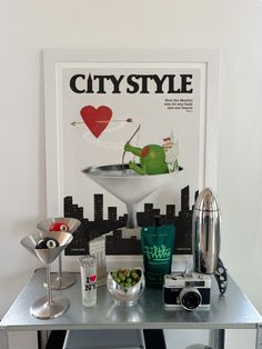 a silver table topped with lots of different types of food and drink items on top of it