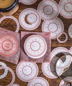 the table is covered with plates and silverware on top of paper napkins that have been cut into circles