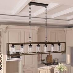 a kitchen with an island and hanging lights