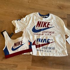 New, Never Worn With Tags Attached Nike Set. Lined Sports Bra And Cropped Tshirt. Both Size Small. Matching Set. Small Spot Of Discoloration On The Tshirt As Show In The Eighth Photo. It Looks Like It Will Likely Wash Out With A Stain Remover But Can’t Be Guaranteed. Tshirt Originally Retails For $58 And Bra Originally Retails For $55. From A Smoke Fee Household. Red Athleisure T-shirt For Sports Season, Nike Summer Workout T-shirt, Nike Crew Neck Tops For Sports Season, Nike Crew Neck Sportswear Top, Nike Sportswear Crew Neck Tops, Summer Sports Tops With Three Stripes Branding, White Graphic Print Sports Top, Nike Sporty Tops For Sports Season, Nike White Sports Top