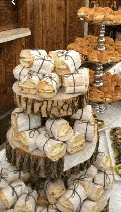 there are many sandwiches and pastries on the table at this wedding or bridal party