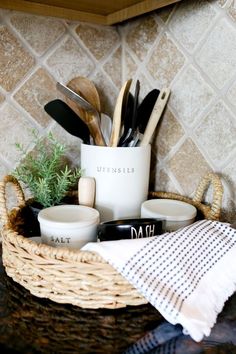 a basket with utensils and spoons in it sitting on a counter top