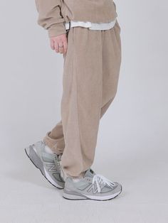 Editor's NotesThese jogger pants feature light and thick cotton-polyester blended fabric  waist banding with drawstring. It can be styled in various ways. For unisex.- Waffle texture of light and thick cotton-polyester blended fabric- Warm and soft- Waist banding with drawstring- Side and back pockets - Loose fitMeasurements (in.)M / L- Total length: 38.19 in. / 39.76 in.- Waist: 14.17 in. / 15.35 in.- Thigh: 12.20 in. / 12.99 in.- Rise: 9.84 in. / 10.63 in.- Hem: 5.51 in. / Winter Beige Relaxed Fit Sweatpants, Beige Cotton Joggers With Elastic Waistband, Beige Relaxed Fit Joggers For Loungewear, Casual Beige Bottoms With Ribbed Waistband, Baggy Beige Bottoms For Loungewear, Beige Athleisure Sweatpants For Streetwear, Beige Drawstring Sweatpants For Loungewear, Casual Khaki Sweatpants With Drawstring, Casual Cream Sweatpants With Ribbed Waistband