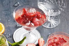 three glasses filled with fruit and ice on top of a table