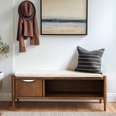 a bench with a hat and scarf hanging on the wall