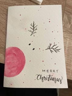 a christmas card with the words merry christmas written in black and red ink on it