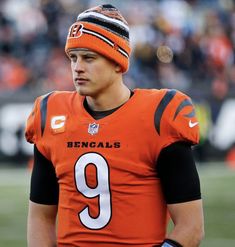 a close up of a football player wearing an orange uniform