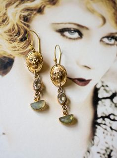 Antique gold plated lion head cuff links repurposed into unique drop earrings, I've paired the links with a clear glass bracelet link in the center and added a unique shape Labradorite drop at the bottom. I love the ear wire I've used the little ball on the wire mimics the texture around the cufflink. Again, like all my jewelry they are one of a kind, easy to dress up or down. Length: 2"1/2 inches long, lightweight. One Of A Kind Brass Dangle Jewelry, One Of A Kind Brass Dangle Earrings, Oval Pierced Brass Jewelry, Antique Brass Clip-on Jewelry, One Of A Kind Gold Teardrop Earrings, Unique Gold Oval Earrings, Unique Drop Earrings, Earrings Antique, Glass Bracelet