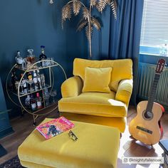 a living room filled with furniture and a guitar