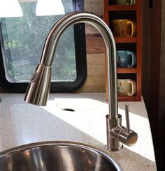 the kitchen sink is clean and ready to be used by someone in their rv or camper