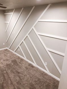 an empty room with white paint on the walls and carpeted floor in front of it