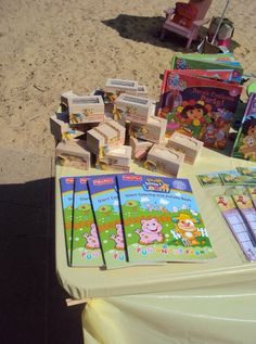 children's books and games on a table at the beach