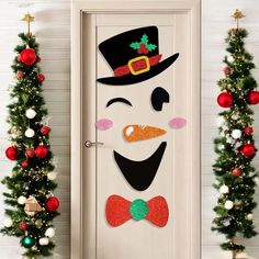 a door decorated with christmas decorations and a snowman's face