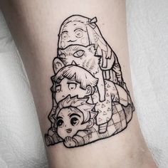 a black and white photo of some cartoon characters on the side of a woman's leg