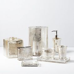 an assortment of bathroom accessories including soap dispenser and toothbrush holder