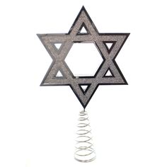 a star of david hanging from a wire on top of a white wall with spirals