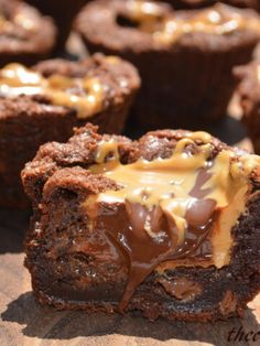 chocolate cupcakes with caramel drizzled on top and one cut in half