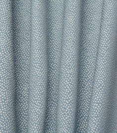 a close up view of a blue and white curtain