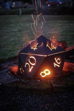 a lit up dice sitting on top of a fire pit