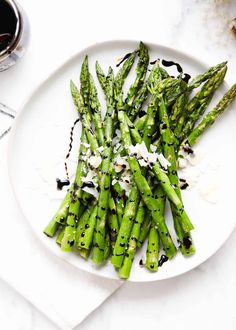 asparagus with parmesan cheese on a white plate