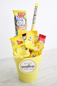 a yellow bucket filled with snacks and candy