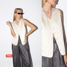 This vintage cream women's suit vest from the 1980s features an elegant embroidered pattern and covered buttons. With an adjustable silver buckle at the back and two front pockets, this shiny oversize vest by MASTERHAND® adds a touch of retro sophistication to any outfit. 👉 made in 1980s 👉 elegant covered buttons 👉 adjustable at the back with a silver buckle 👉 2 front pockets 👉  embroidered pattern with waves and leaves 👉 shiny material 👉 oversize fit - fits most sizes (see measurements!) Oversize Vest Outfit, Oversized Vest Outfit, Womens Suit Vest, Retro Vest, Cream Suit, Oversized Vest, Vest Outfit, Vest Outfits, Suit Vest