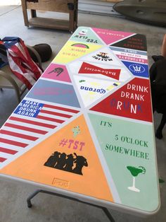 a table with several different colored signs on it and people sitting at tables in the background