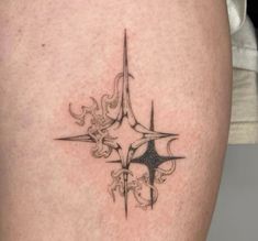 a close up of a person's thigh with a tattoo design on the leg