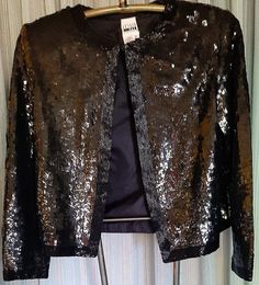 This jacket is in excellent condition.   It has a hook and eye closure at rhe top and is worn open.  Jacket nicely lined.  The only thing I saw was at the back of the neck there are some loose thread but beads intact.  Armpit to armpit is 19 1/2 inches long.  Sale is final. Winter Outerwear With Sequins, Open Jacket, Evening Jackets, Black Beads, Bathing Beauties, Jackets For Women, Jackets & Coats, Music Clothes, Clothes For Women