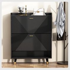 a black cabinet with gold handles in a living room or dining room area next to a coat rack