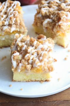 three pieces of cake on a plate with apples in the backgroung behind it