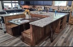 a large kitchen island with two stools in front of it and an open floor plan