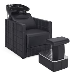 a black chair and footstool are sitting next to each other