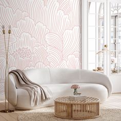 a living room with white furniture and pink wallpaper