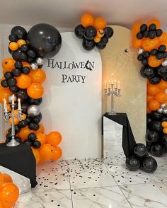 an orange and black halloween party with balloons