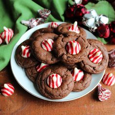 a white plate topped with chocolate cookies covered in candy canes