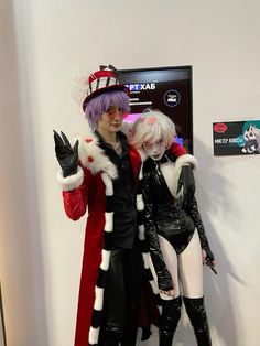 two people dressed in costumes standing next to each other