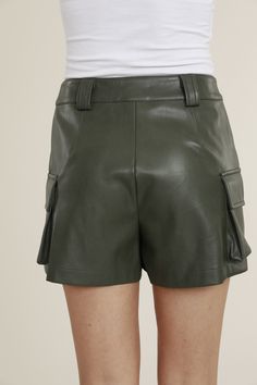 The Cargo Skort by Dolce Cabo adds a streetwear twist to the classic leather skirt. Style with a graphic tee and sneakers for a casual but cute look! Leather Skort, Sporty Summer, Metallic Midi Skirt, Faux Leather Midi Skirt, Midi Skirt With Pockets, Pretty Skirts, Oversized Turtleneck, Leather Midi Skirt, Metallic Skirt