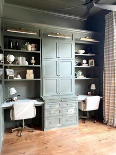 an office with gray cabinets and wooden floors