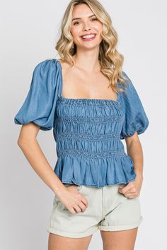 Denim smocked peplum look top. Features: regular size, standard, young contemporary, contemporary, peplum look, denim, smocked detail, top, blouse, short sleeves, puff sleeves, square neck, low back, cute, trendy, stylish, fashionable, daily wear, everyday wear, spring, summer, ss, women's clothing, women's apparel, women's wear Fabric Content 100% Lyocell Care Instruction Hand Wash Cold, Do Not Bleach, Hang To Dry Summer Medium Wash Denim Top With Puff Sleeves, Medium Wash Puff Sleeve Denim Top For Summer, Medium Wash Denim Top With Puff Sleeves For Summer, Chic Short Sleeve Peasant Top With Smocked Back, Short Sleeve Smocked Bodice Top For Brunch, Smocked Bodice Short Sleeve Top For Brunch, Ruched Puff Sleeve Top For Day Out, Summer Puff Sleeve Denim Top, Casual Puff Sleeve Top With Smocked Bodice