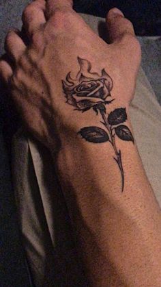 a person's foot with a rose tattoo on it