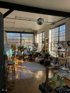 a living room filled with furniture and lots of windows