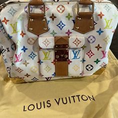 Louis Vuitton White Monogram Multicolore Speedy 30 Rare No Longer Sold In Stores ! Used Condition- Light Marks. Bag Has Slight Loss Of Shape From Storage. Handles Are Discolored. Hardware Is In Great Condition. Please See Pictures For Condition Or Ask ! Material: Coated Canvas, Leather Handle Drop: 4.5 Dimensions: 12.25 X 10.0 X 7.0 Origin: France Circa: 2003 Hardware: Gold Tone Closure: Zipper Pockets: One Exterior, One Interior Lining: Red Alcantara * Does Not Come With Keys Original Price Was $3150 Open To Offers That Are Reasonable- Or Selling On A Different Platform For Less Louis Vuitton White, Speedy 30, Canvas Leather, Leather Handle, Womens Tote Bags, Red Gold, Louis Vuitton Bag, Zipper Pocket, Red And White