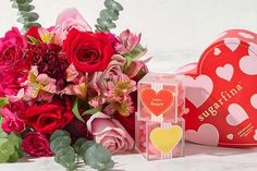 valentine's day gift set with roses, heart shaped box and flowers in it